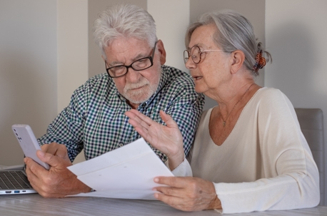elderly couple reviewing documents
